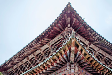 Fototapeta na wymiar Wooden Structure Of Traditional Chinese Roof Of Pagoda In Kumbum Monastery.