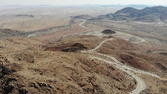 Arid desert landscape of Central Khomas Highland with very steep Spreetshoogte Pass Road in Namibia, Aerial drone shot