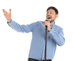 Naklejka premium Handsome man singing in microphone on white background
