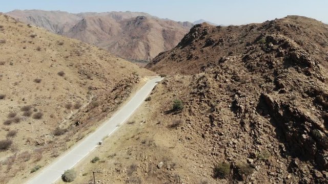 Arid desert landscape of Central Khomas Highland with very steep Spreetshoogte Pass Road in Namibia, Aerial drone shot