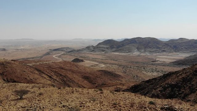 Arid desert landscape of Central Khomas Highland with very steep Spreetshoogte Pass Road in Namibia, Aerial drone shot