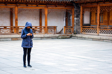 The Woman Is Using Phone In The Historical Place.