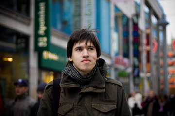 Fototapeta premium Young man tourist in a city street