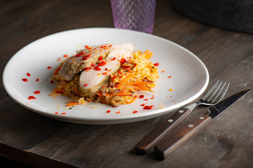 Grilled chicken on fried riced toped with chili..​