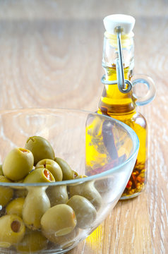 Olives in a bowl and virgin olive oil