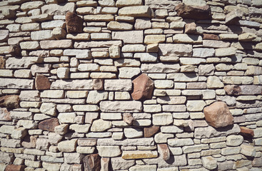 Old stone wall background, color toning applied.