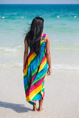 Back view of an asian woman standing at the sea