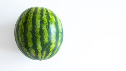 Ripe single full watermelon berry isolated on white background.