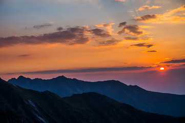 Beautiful landscape with high mountains , blue sky and yellow sunlight in sunrise.
