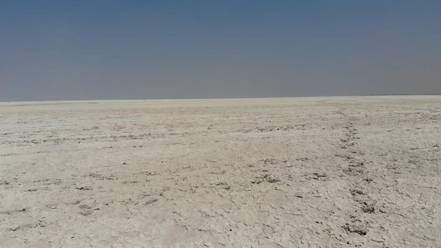Arid desert landscape of Makgadikgadi Pans area of Central Botswana with dry salt pans and savannah landscape, Aerial drone shot