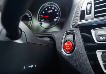 Red start-stop button in a car