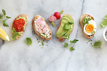 Breakfast sandwich bread with avocado, egg, radishes and tomatoes. Bruschetta or healthy snack ideas