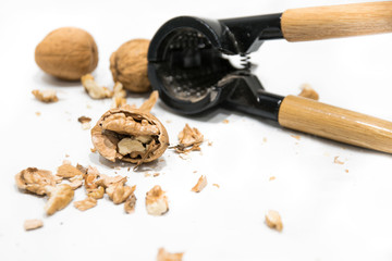 Nutcracker, walnut kernel peeled and whole nutshells, isolated on a white background.