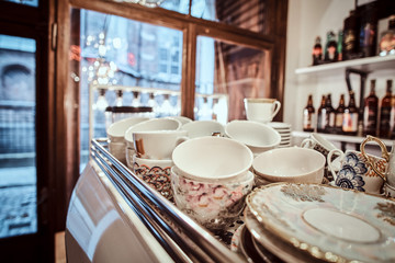 Clean dishes in a coffee shop in the background with a showcase