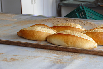 baker fills bread baked in stone oven to bread crates, breads filled in bread crates for sale,