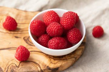 Fresh Raspberries In A Bowl On Linen Background, Top View