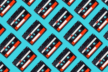 Audio cassette pattern on colored background. Audio cassette tape. Vintage disco poster. Pattern of...