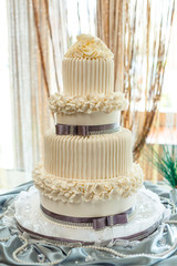 Big two-level anniversary (wedding) cake with flowers from pearl cream.