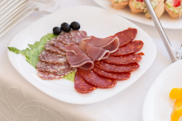 slices of salami and meat on the festival table