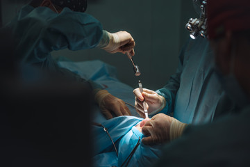 The surgeon uses a chisel and a hammer