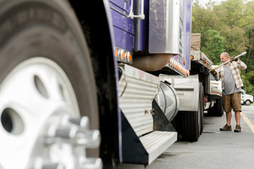 Truck driver working on semi-truck