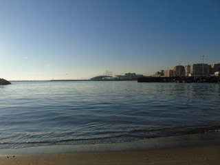 Genova, Italy - 02/14/2019: An amazing caption of the sunset over the sea and the city of Genoa in winter days and great views to the old buildings near the beach coloured by the sun