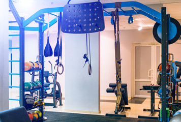 Modern equipment for doing sport exercises in the light gym. Fitness and gym workout items in sports club