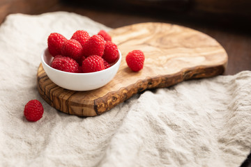 Fresh Raspberries In A Bowl On Linen Background, Top View, Space For Text