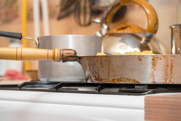 Fototapeta na wymiar Pan on the gas stove close-up. Kitchen utensils