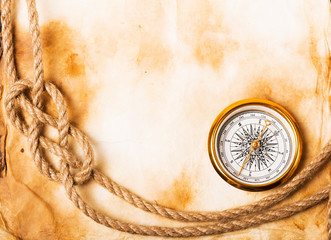 old compass and rope on grunge background
