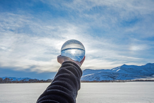 Hand of man holding glass orb in Picabo, Idaho