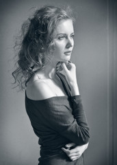 Fototapeta premium Beautiful blonde woman at the window with natural day light.