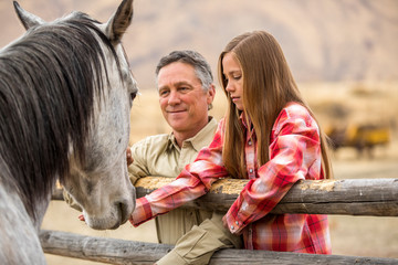 Man with his granddaughter and horse