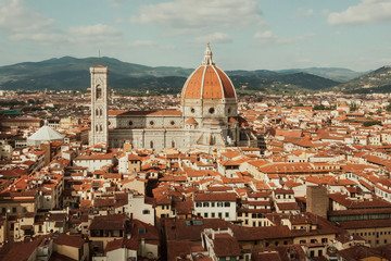 Fototapeta premium Florence cityscape. Red tile roofs and 14th century Duomo in historical area, Italy