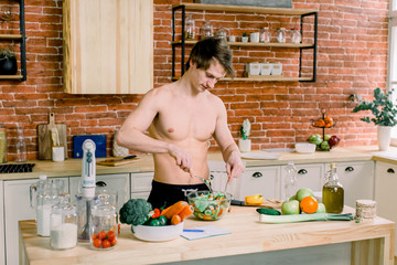 Man preparing delicious and healthy food in the home kitchen on a sunny day.