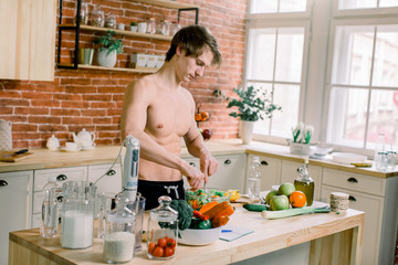 Man preparing delicious and healthy food in the home kitchen on a sunny day.