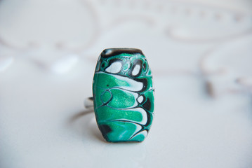 Handmade jewelry of polymer clay. Abstract boho ring in macro. Fashion design jewelry.