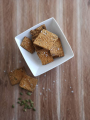 homemade crackers in a bowl and pumpkin seeds on the table