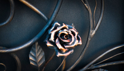 Decorative elements of the fence in the form of metallic flowers