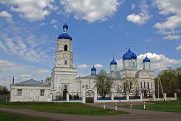 Fototapeta premium Old white stone Orthodox church with blue domes