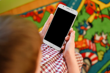 A boy use phone with empty screen on blurred colorful background