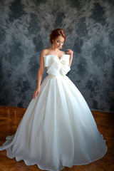 Fototapeta na wymiar beautiful bride in wedding dress, beautiful make-up and styling