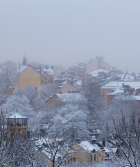 Old houses on a hill in Stockholm on a foggy winter day with snow on, Sweden