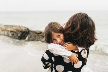 portraits of mom and daughter on the  sea beach