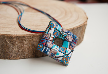 Handmade jewelry from polymer clay. Boho ethnic  pendant. Fashion jewelry.Still life. Organic Accessories