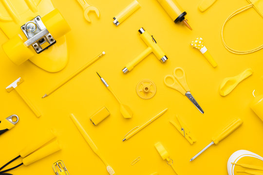 top view of random yellow objects in order on yellow background