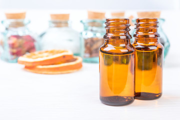 Essential oils in glass bottles on the wooden background