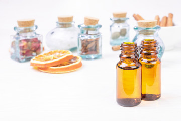 Essential oils in glass bottles on the wooden background