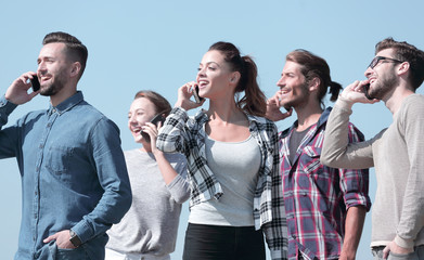 closeup of a group of young people with smartphones.