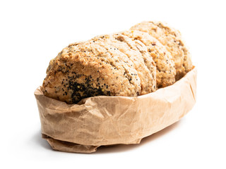 Wholemeal seeded scones on paper bag isolated on white